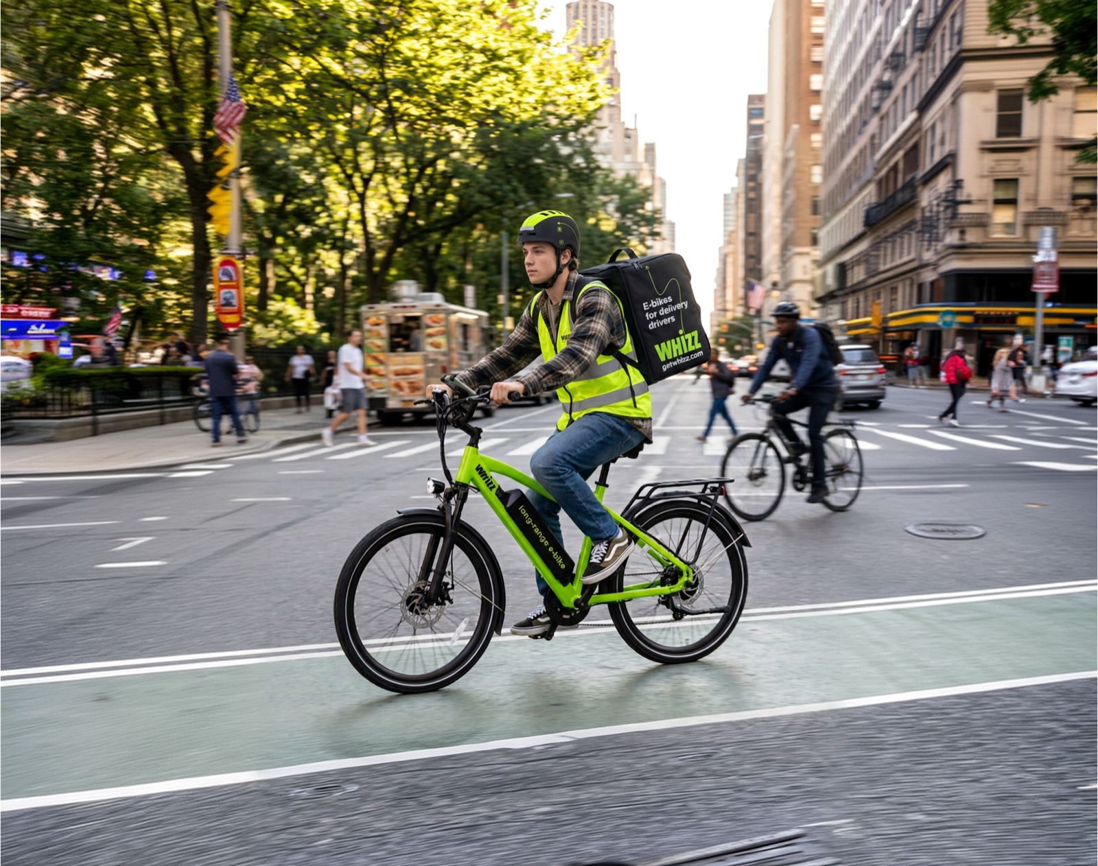 Young delivery rider in a helmet and reflective vest riding a green Whizz e-bike through a city street